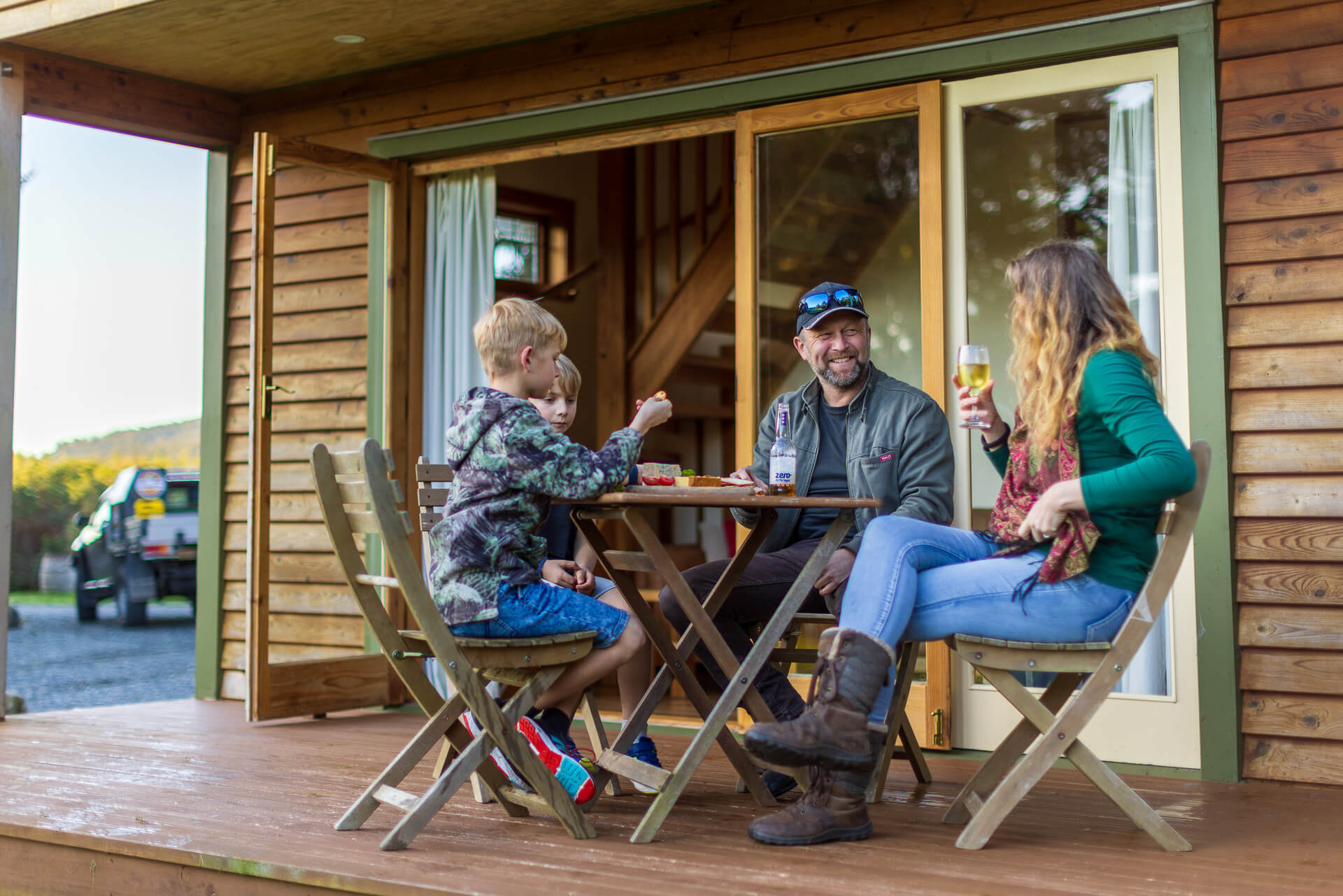 Family dining at table in front of chalet