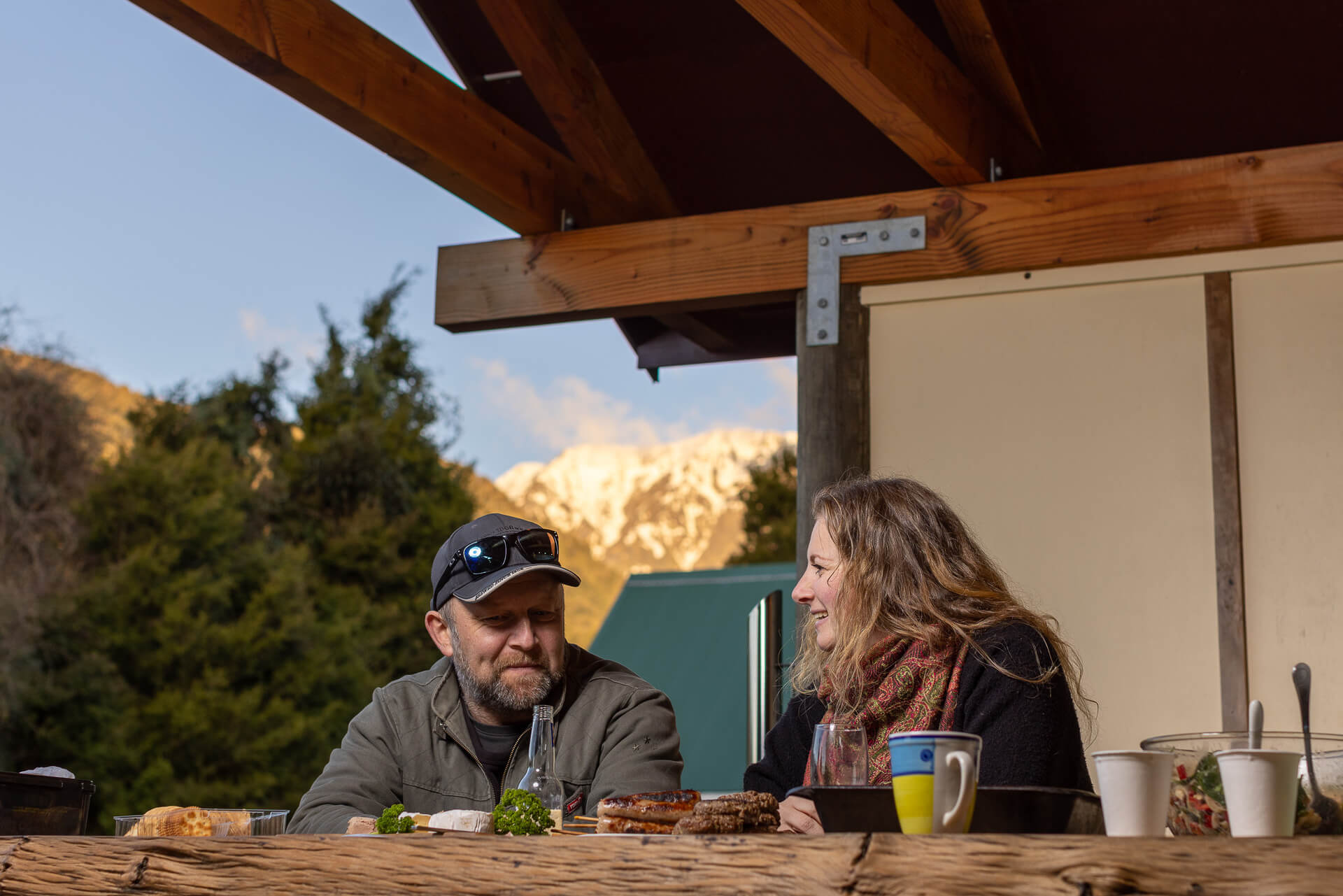 Two guest enjoying dinner underneath covered bbq area