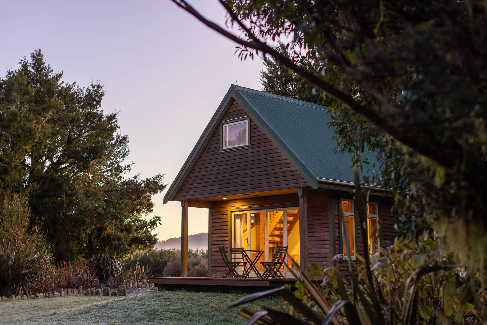 Chalet at sunrise with blue skies and dew on lawns