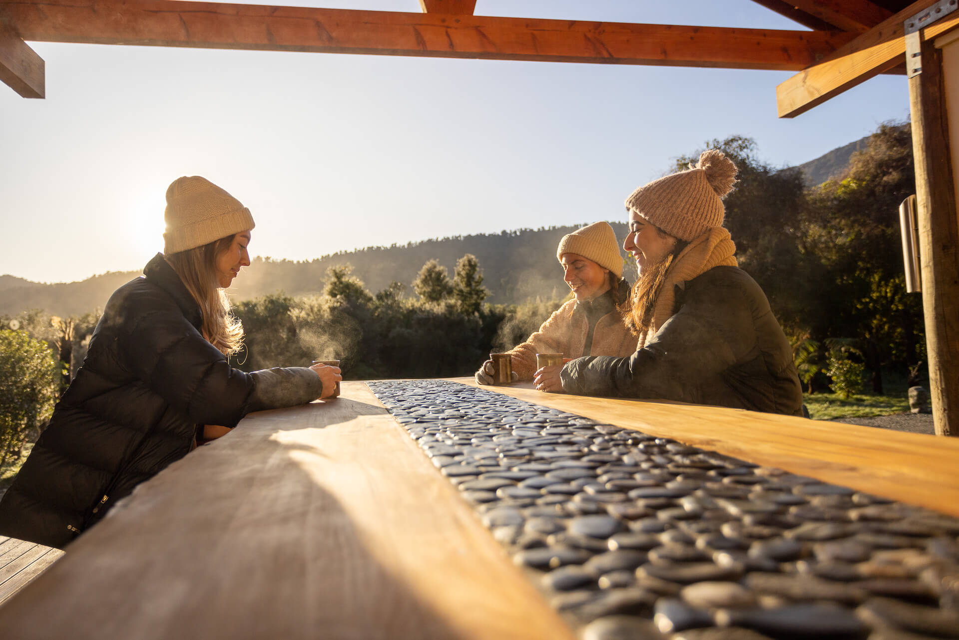 guests enjoying hot coffee at table in bbq area